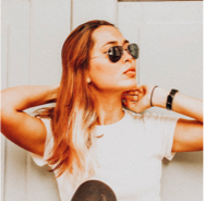 profiile photo of julia: young lady wearing ray-ban aviators in a white t-shirt looking cool while staring off to the side